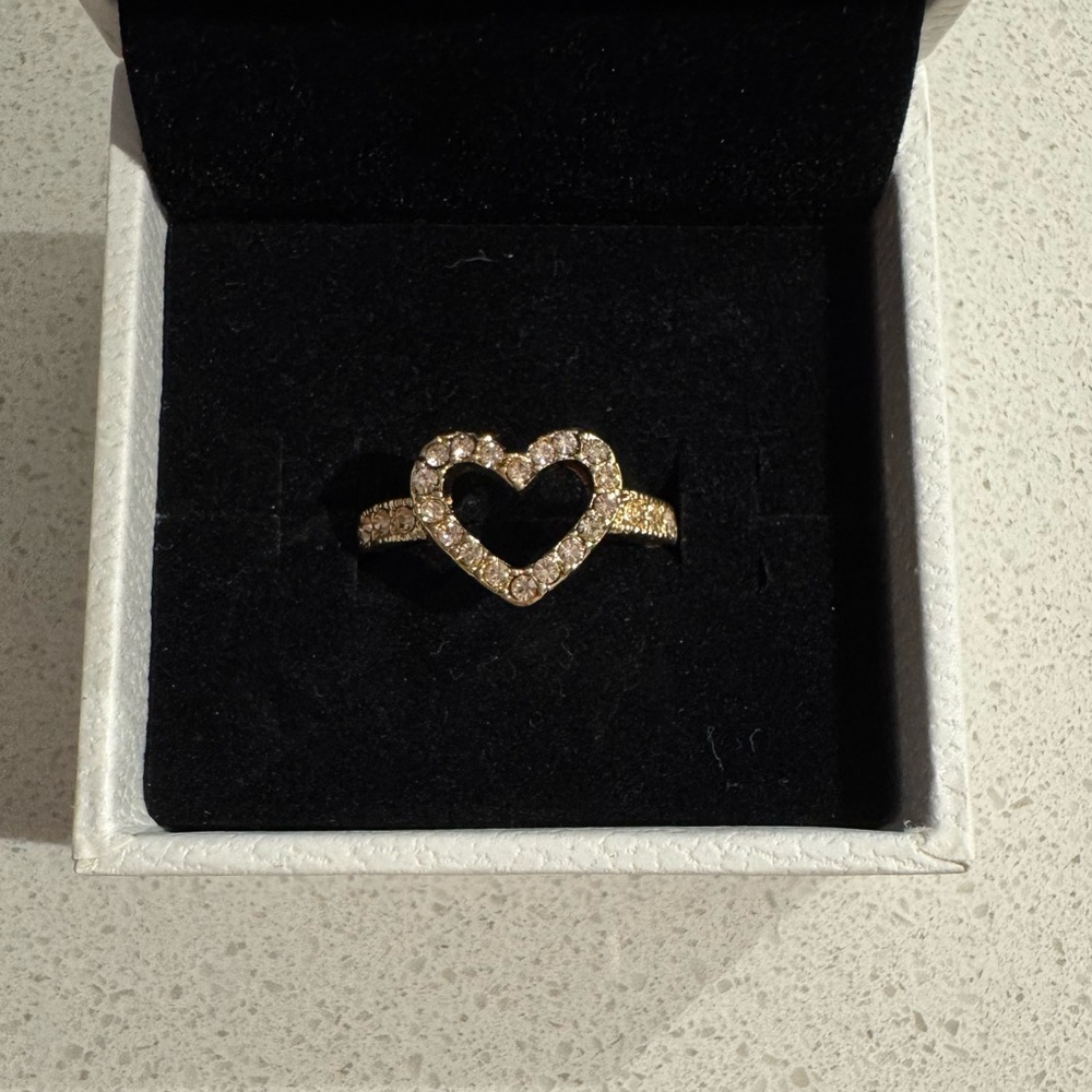 Gold bejeweled open heart ring